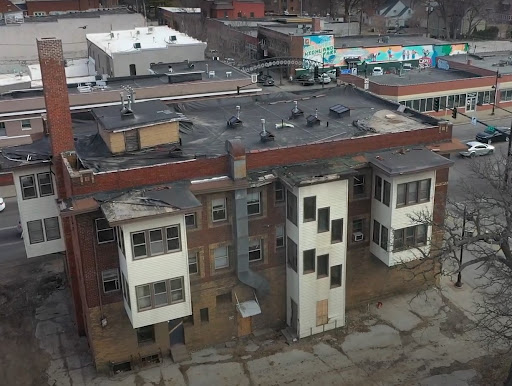 The exterior of a dilapidated apartment and commercial building in Des Moines