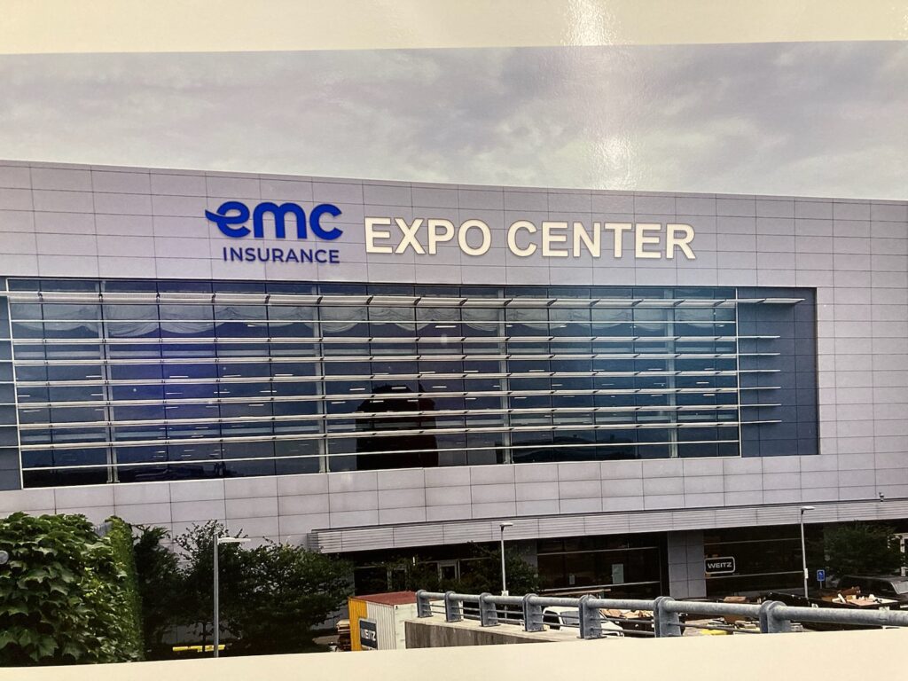 Rendering of a building with the words EMC Expo Center in blue and white letters