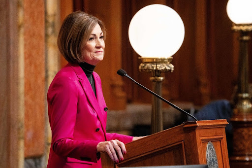 Kim Reynolds speaking at a podium