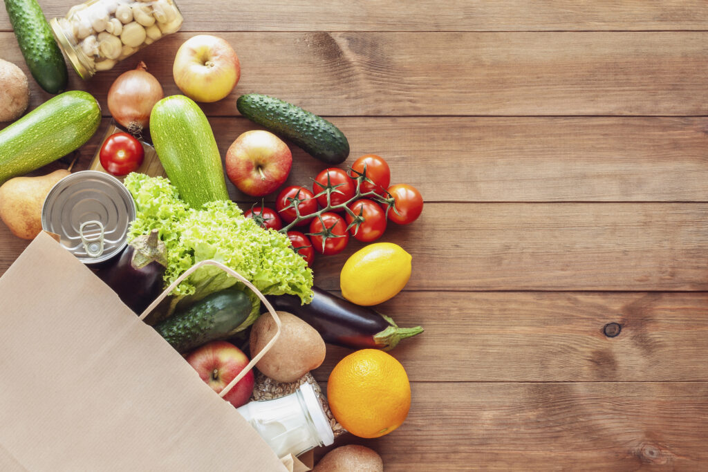 Paper shopping food bag with grocery and vegetables